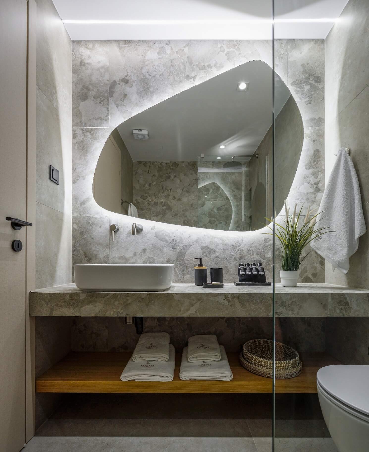 The bathroom with its backlit mirror