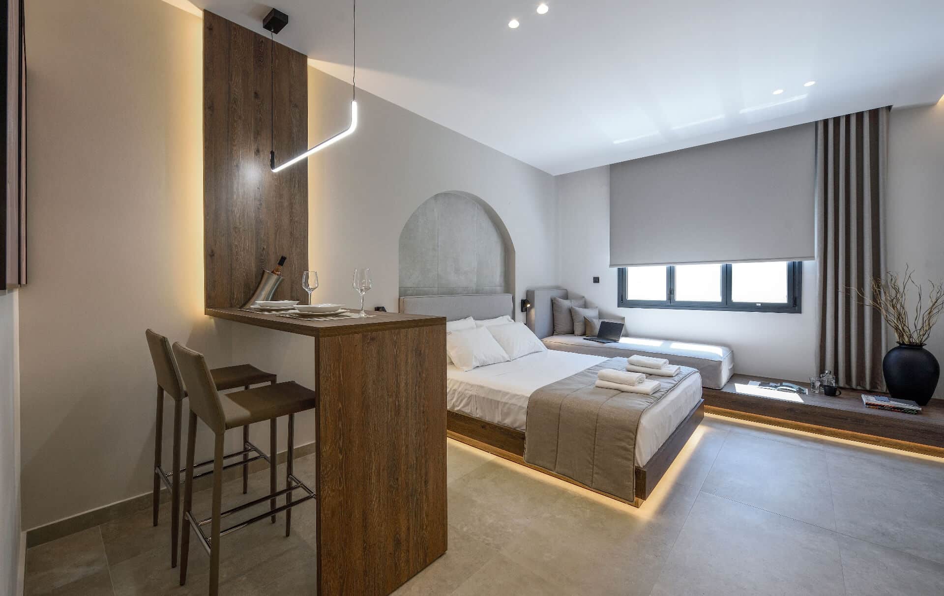 The suite from the bar corner: the queen bed, the daybed by the window and the table