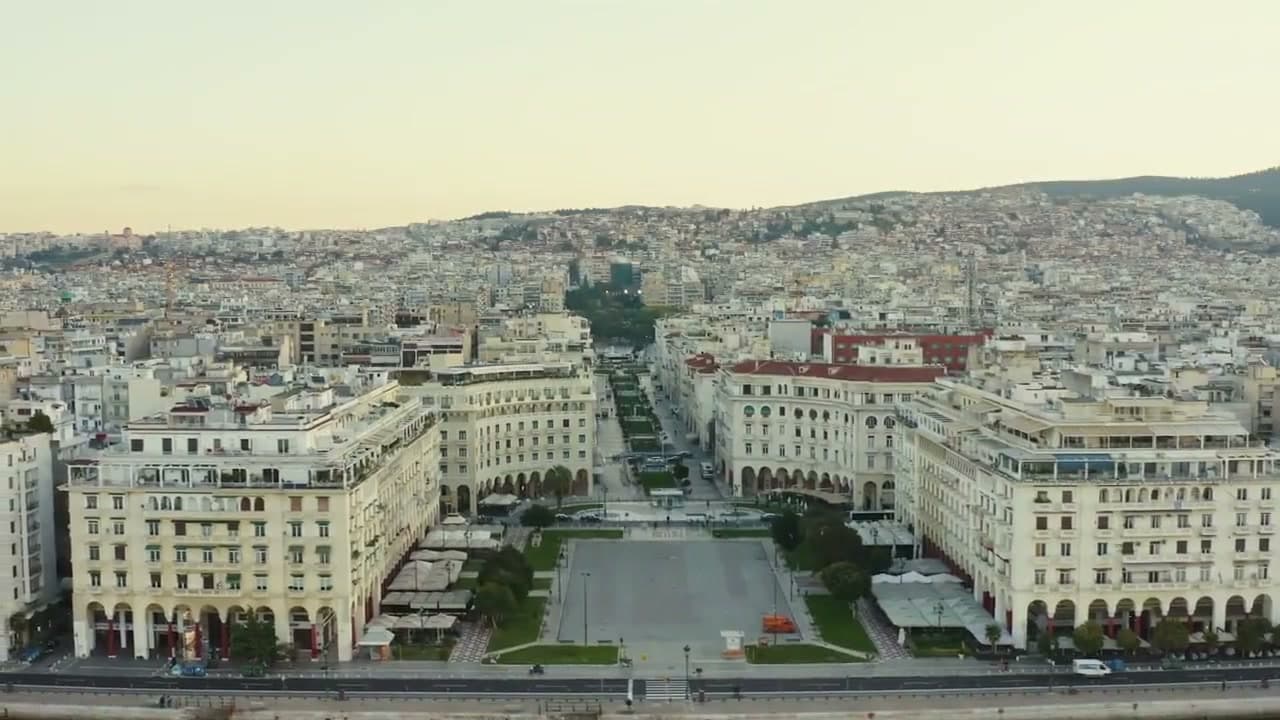 Aristotelous Square seen from over the water, the city rising to the hills behind it