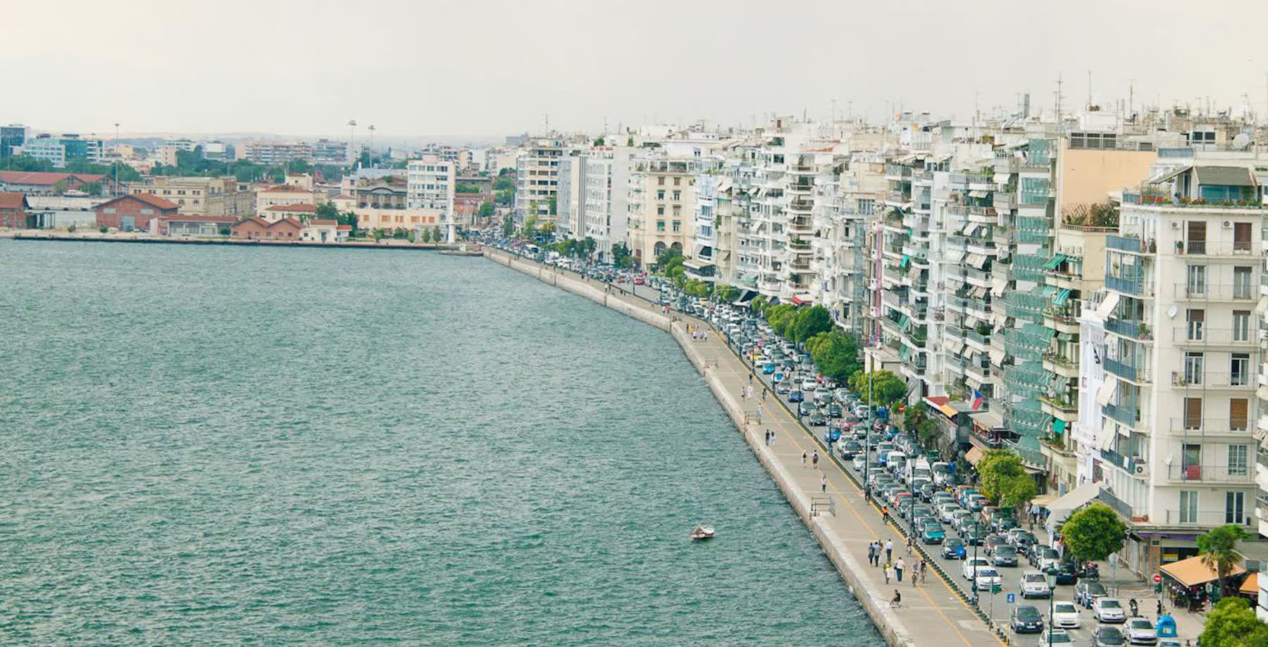 The Nikis Avenue waterfront curve with rows of parked cars
